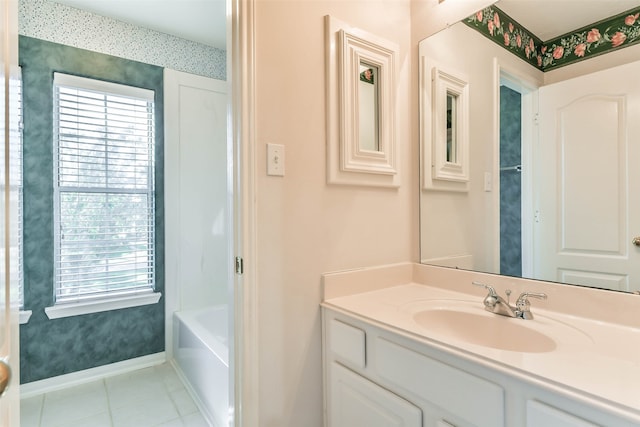 bathroom with tile patterned floors, plus walk in shower, vanity, and a healthy amount of sunlight