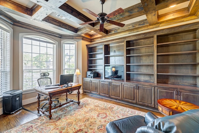 home office with coffered ceiling, ceiling fan, ornamental molding, and light hardwood / wood-style flooring