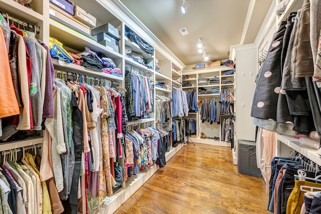 walk in closet featuring light hardwood / wood-style flooring