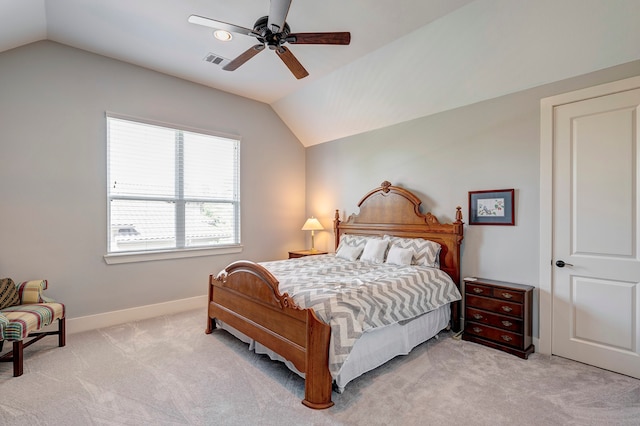 carpeted bedroom with ceiling fan and vaulted ceiling