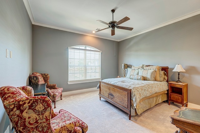 carpeted bedroom featuring ceiling fan and crown molding