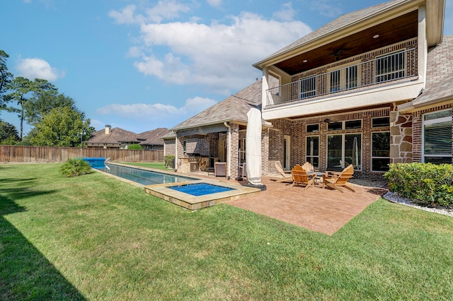 back of house with a lawn, ceiling fan, a balcony, area for grilling, and a patio