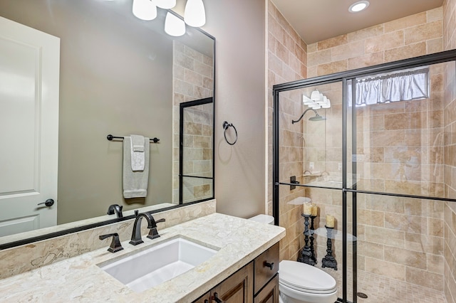 bathroom with vanity, toilet, and walk in shower