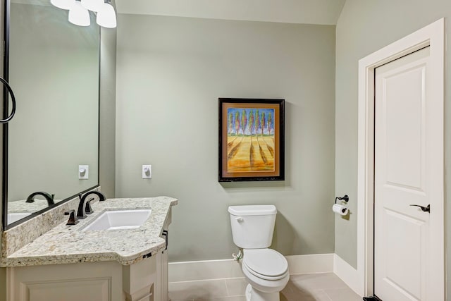 bathroom featuring tile patterned flooring, vanity, and toilet