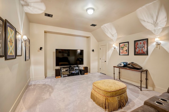 sitting room featuring light colored carpet and vaulted ceiling