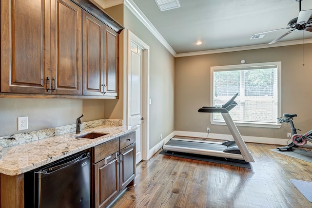 interior space with ceiling fan, ornamental molding, sink, and light hardwood / wood-style flooring