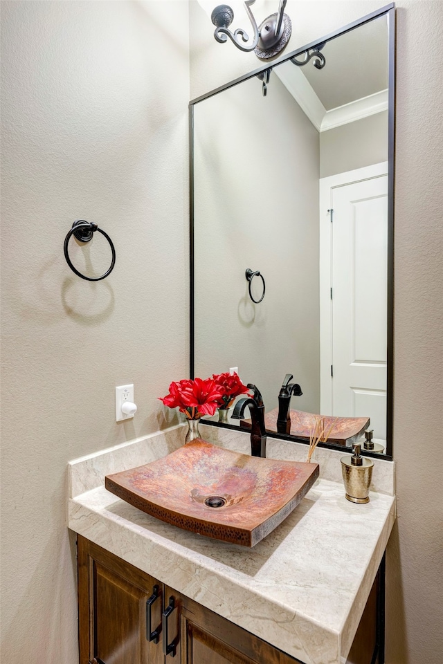 bathroom featuring vanity and ornamental molding