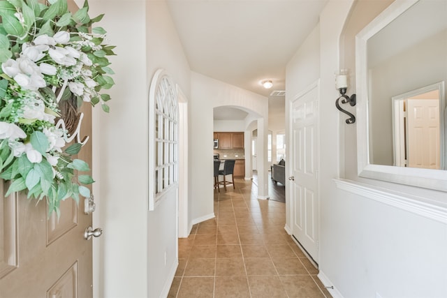 corridor with light tile patterned floors