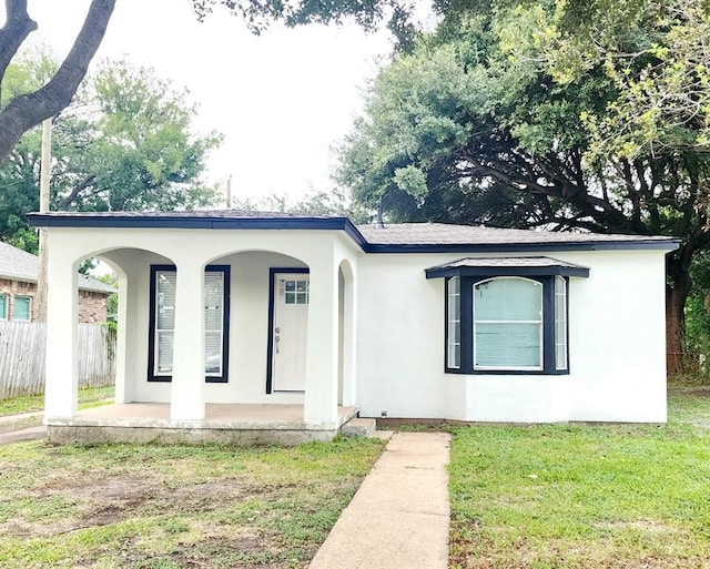 view of front of home with a porch and a front yard