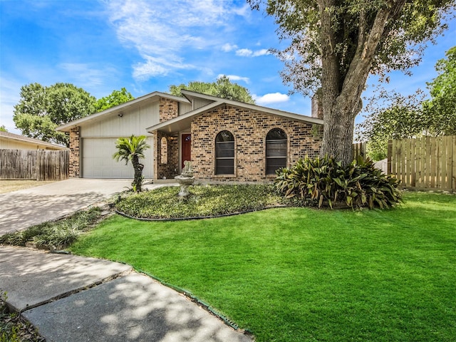 view of front of house featuring a garage and a front lawn