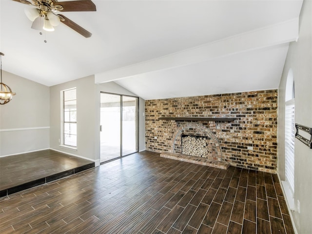 unfurnished living room with ceiling fan, dark wood-type flooring, a brick fireplace, vaulted ceiling with beams, and brick wall