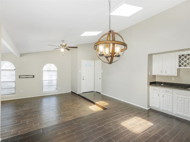 interior space featuring dark hardwood / wood-style floors, decorative light fixtures, and a wealth of natural light