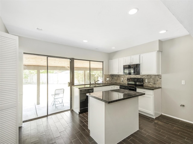 kitchen with white cabinets, dark wood-type flooring, and black appliances