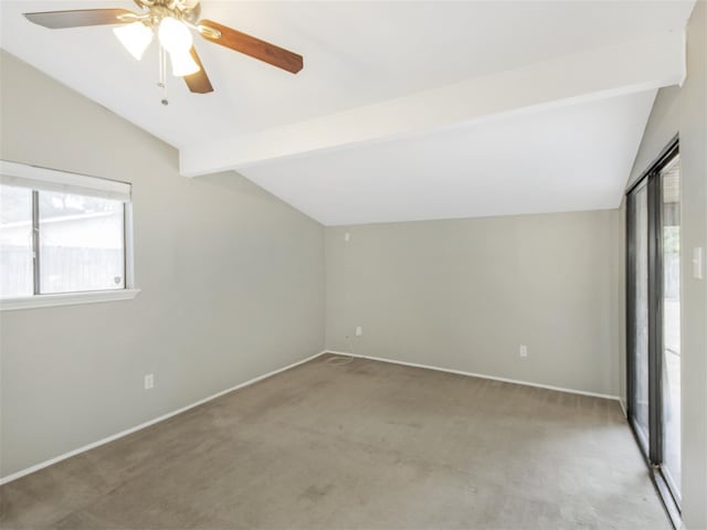 interior space with ceiling fan, carpet floors, and lofted ceiling with beams