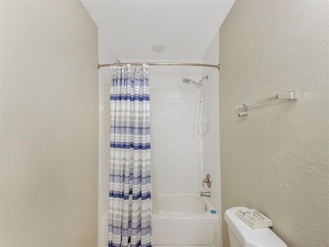 bathroom featuring shower / bath combo with shower curtain and toilet