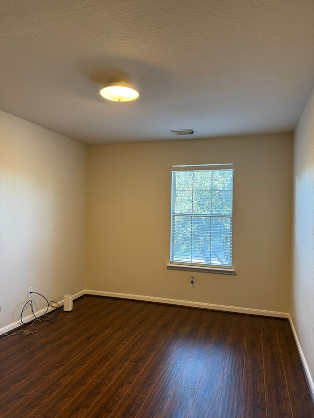 empty room featuring dark hardwood / wood-style flooring