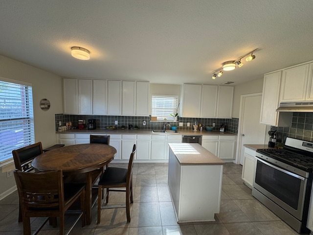 kitchen with white cabinetry, a kitchen island, stainless steel range oven, and black dishwasher