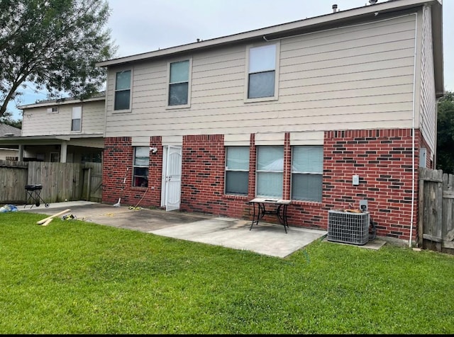 back of house featuring a patio area, a yard, and central AC unit