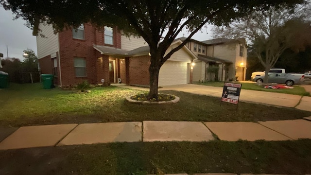 front facade with a front yard and a garage