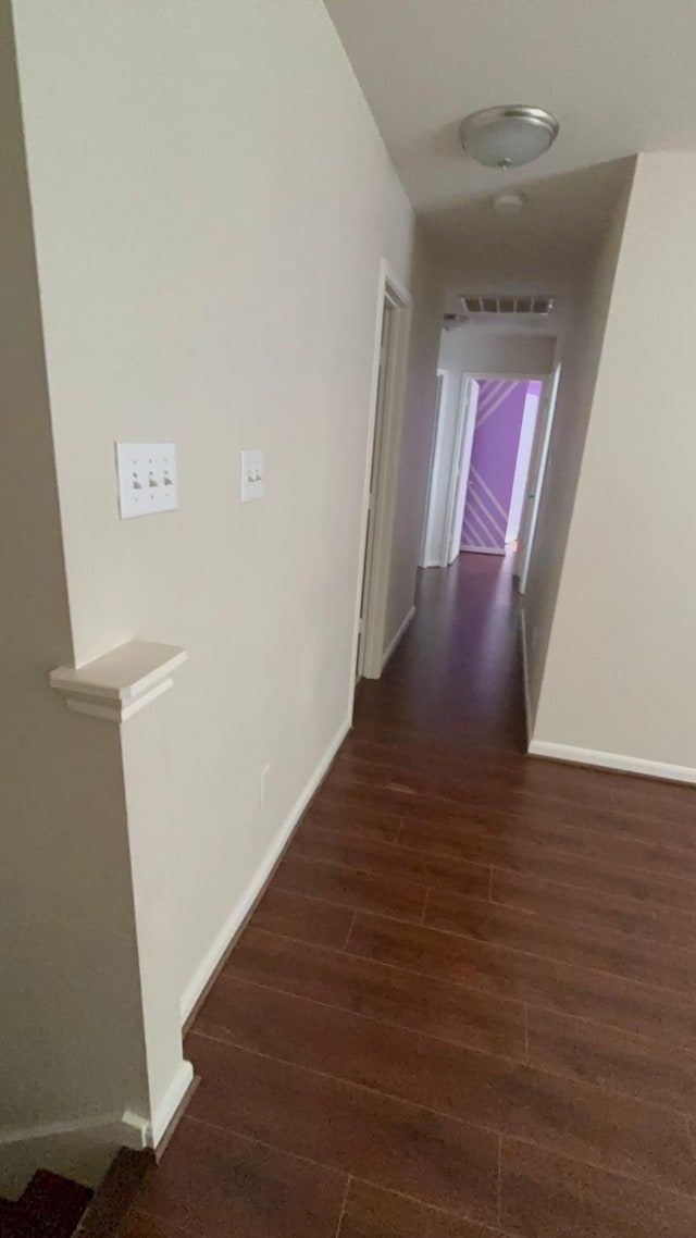 corridor featuring dark hardwood / wood-style floors