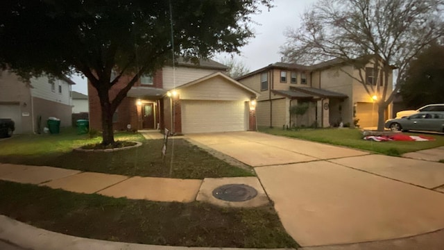 view of front of house with a garage and a front lawn