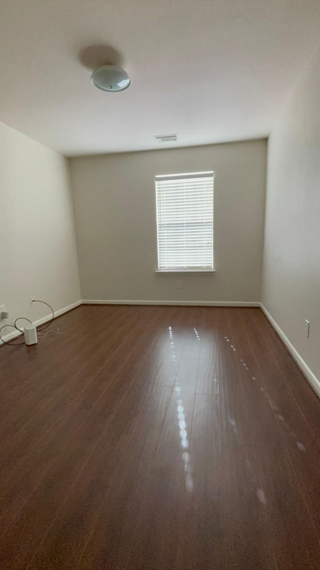 empty room featuring dark wood-type flooring