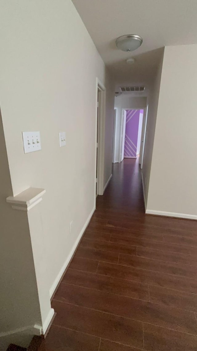 corridor with dark wood-type flooring