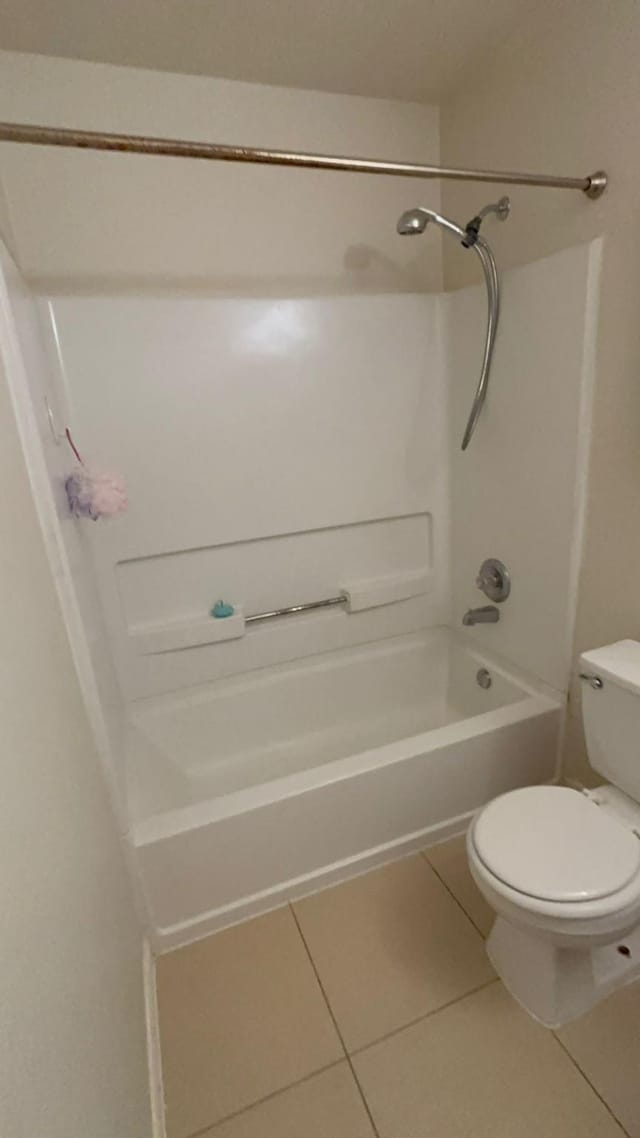 bathroom featuring toilet, bathing tub / shower combination, and tile patterned floors