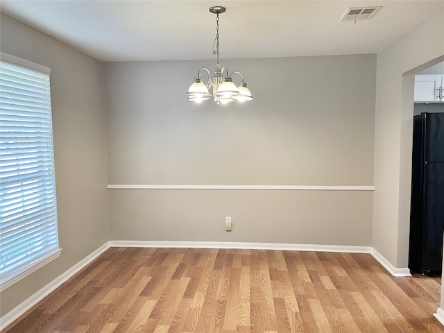 interior space with a chandelier and light hardwood / wood-style flooring