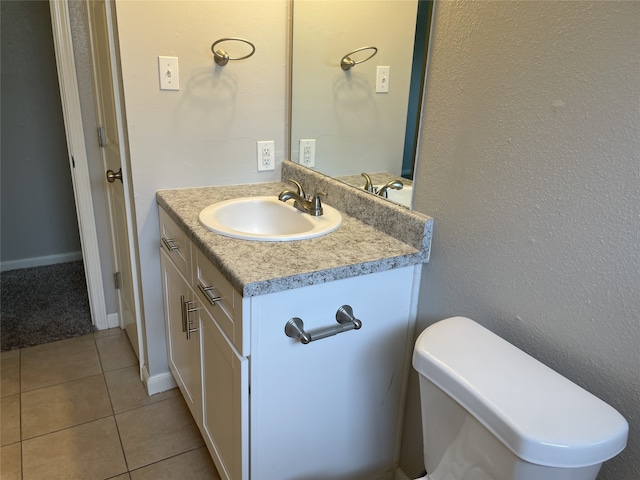 bathroom featuring tile patterned floors, vanity, and toilet