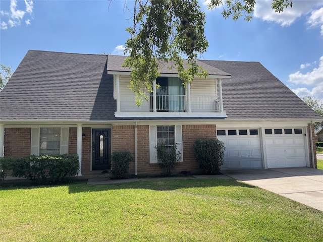 view of property featuring a garage and a front lawn