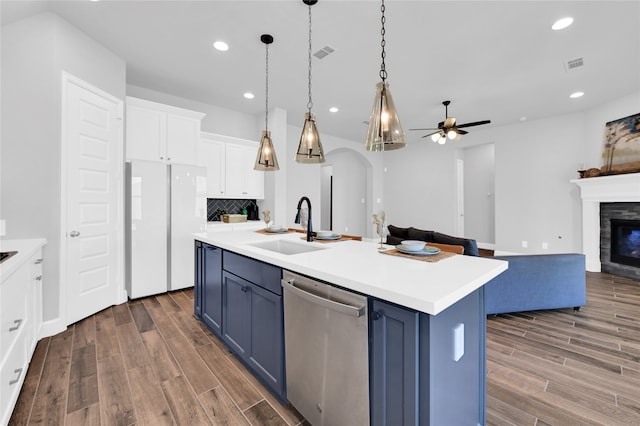 kitchen featuring white cabinetry, sink, stainless steel dishwasher, blue cabinets, and a center island with sink