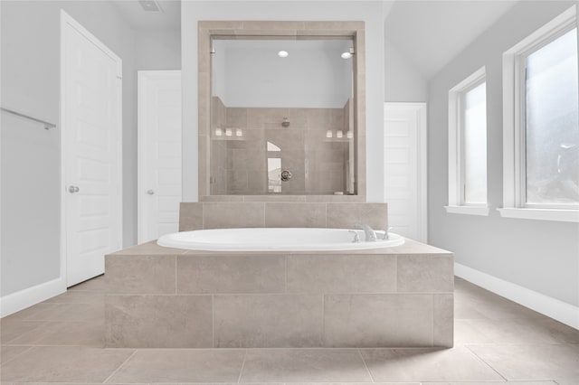 bathroom with tile patterned flooring, plus walk in shower, and vaulted ceiling