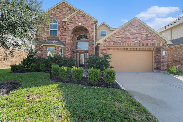 front of property with a garage and a front lawn