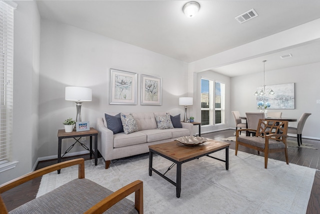 living room with a chandelier and light hardwood / wood-style flooring