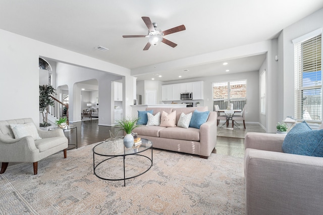 living room featuring ceiling fan and light hardwood / wood-style floors