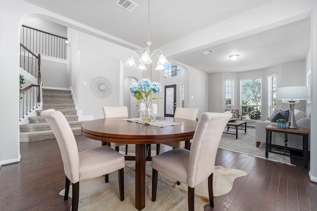 dining room featuring dark hardwood / wood-style floors and a chandelier