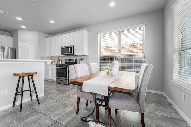 dining area featuring light tile patterned floors