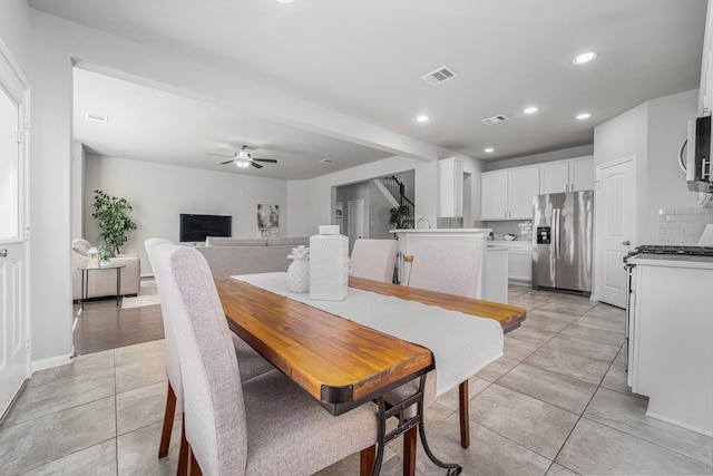 dining space with ceiling fan and light tile patterned floors