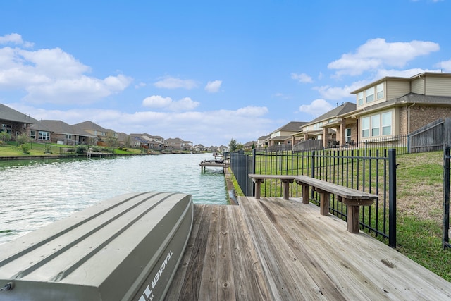 dock area with a yard and a water view