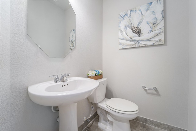 bathroom with sink, tile patterned flooring, and toilet