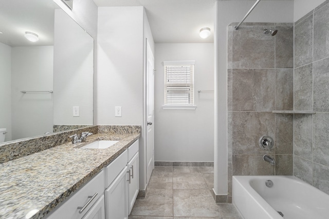 bathroom featuring vanity and tiled shower / bath