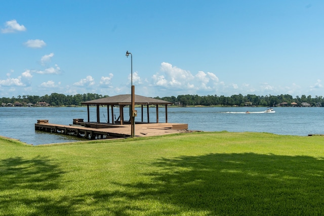 dock area with a water view and a lawn