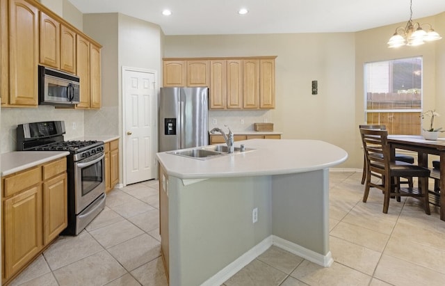 kitchen with sink, pendant lighting, a chandelier, a kitchen island with sink, and appliances with stainless steel finishes