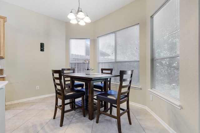 dining space featuring light tile patterned floors and a notable chandelier