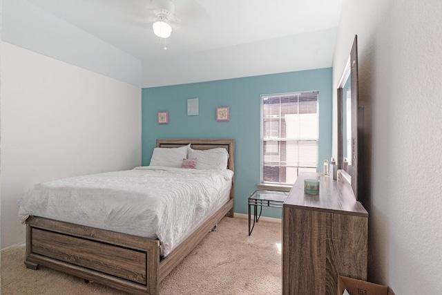 bedroom with ceiling fan and light carpet