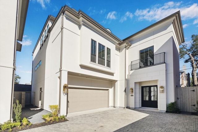 view of front of house featuring a garage and a balcony