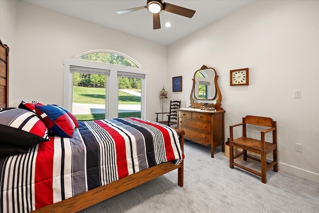 bedroom with light colored carpet, ceiling fan, and lofted ceiling