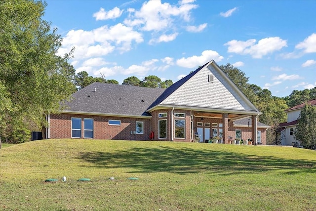 back of property featuring a lawn and central AC unit