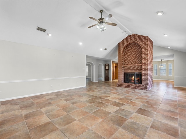 unfurnished living room featuring lofted ceiling with beams, ceiling fan, and a fireplace